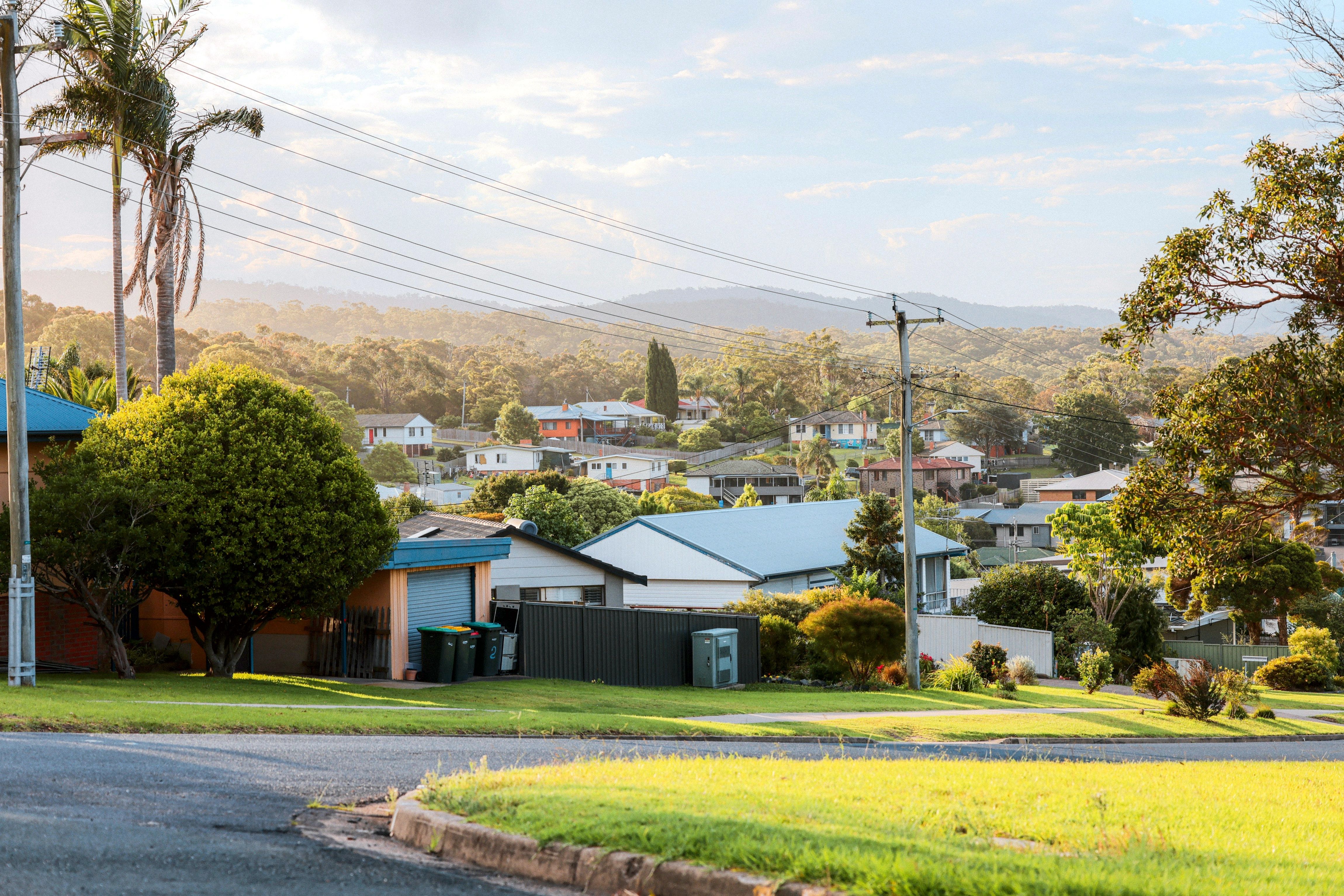 Street of houses in a Brisbane suburb with hills behind